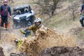 Sportsmen on BRP Can-Am quad bikes drive splashing in dirt and water at Mud Racing contest. ATV SSV motobike competitions are Royalty Free Stock Photo