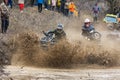 Sportsmen on BRP Can-Am quad bikes drive splashing in dirt and water at Mud Racing contest. ATV SSV motobike competitions are Royalty Free Stock Photo