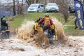 Sportsmen on BRP Can-Am quad bikes drive splashing in dirt and water at Mud Racing contest. ATV SSV motobike competitions are Royalty Free Stock Photo