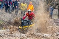 Sportsmen on BRP Can-Am quad bikes drive splashing in dirt and water at Mud Racing contest. ATV SSV motobike competitions are Royalty Free Stock Photo