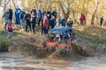 Sportsman on buggy drives splashing in water at Mud Racing contest. ATV SSV motobike