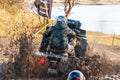 Sportsman on quad bike drives splashing in water at Mud Racing contest. ATV SSV motobike Royalty Free Stock Photo