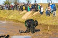 Sportsman on quad bike overturned in water at Mud Racing contest. ATV SSV motobike