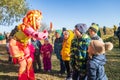 Young woman animator in fairy costume playing with children outdoors in nature at Mud Racing Royalty Free Stock Photo