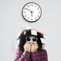 Afraid man biting nail with wall clock Royalty Free Stock Photo