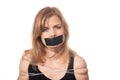 Afraid woman bound by tape and with mouth taped shut. Scared woman tied to chair become slave. Concept of forbidden opinion. male Royalty Free Stock Photo