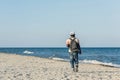 Aframerican black man with backpack on the beach