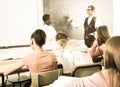 Aframerican schoolboy, answers near blackboard