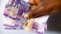 Africa hand Holding 3 Kenya Banknotes of 100 Shillings