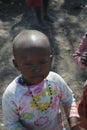 AFRICA, KENYA, MASAI MARA NATIONAL RESERVE, AUGUST 3, 2010: Masai village with masai tribe. Portrait of a little girl of he tribe