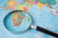 Africa, Magnifying glass close up with colorful world map