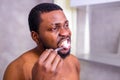 africa man toothbrush in bathroom looking at mirror Royalty Free Stock Photo