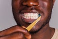 africa man toothbrush in gray background isolate Royalty Free Stock Photo