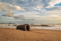 Africa`s gold coast with a hollow log on the beach Royalty Free Stock Photo