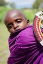 Africa, Tanzania - February 2016: Little baby behind the mother. Masai tribe.