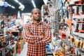 African americam man buying modern electric drill while standing in tool. Hardware construction site objects concept Royalty Free Stock Photo