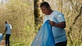 African american activist doing litter cleanup to fight illegal dumping