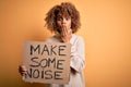 African american activist woman asking for revolution holding banner with make noise message cover mouth with hand shocked with Royalty Free Stock Photo
