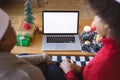 African american adult daughter and mother making christmas laptop video call, copyspace on screen Royalty Free Stock Photo