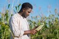 African American agriculturist thoroughly examines corncob