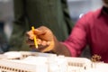 African american architect pointing pencil at architecture model with colleague at workplace Royalty Free Stock Photo