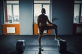 African american athletic man in sport mask put his foot on barbell waiting and preparing before lifting heavy barbell. deadlift w Royalty Free Stock Photo