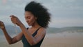 Woman relaxing walking seashore gloomy evening close up. Girl smiling on camera Royalty Free Stock Photo