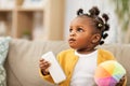 African american baby girl with smartphone at home Royalty Free Stock Photo