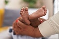 African american baby lying on bed having legs massage at home Royalty Free Stock Photo