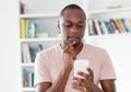 African american bald headed mature man thinking about message Royalty Free Stock Photo