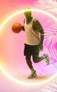 African american basketball player dribbling ball and running by circle and plants Royalty Free Stock Photo