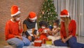African American black family, women and kid girl daughters with face masks sharing gifts on Merry Christmas Eve Xmas Party. Royalty Free Stock Photo