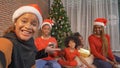 African American black family, women and kid girl daughters sharing gifts on Merry Christmas Eve Xmas Party. They talking video Royalty Free Stock Photo