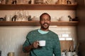 African american black man holding cup of coffee at home