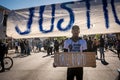 African american black man holding sign for george floyd for justice in minneapolis riots protests and demonstrators close up