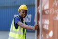 African-American black workers are opening containers for inspection and check that repairs have been completed in containers