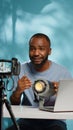 African american blogger reviewing studio light on camera