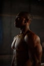 African american bodybuilder model showing muscles in studio on black background Royalty Free Stock Photo