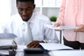 African american bookkeeper or financial inspector making report, calculating or checking balance. Internal Revenu Royalty Free Stock Photo