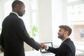 African American boss congratulating Caucasian subordinate with Royalty Free Stock Photo