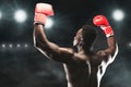 African american boxing champion raising hands up