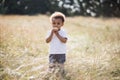 African american boy eating cupcake while standing on field Royalty Free Stock Photo