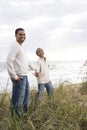 African-American boy and father on beach sand dune Royalty Free Stock Photo