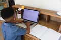 African american boy having video call using laptop during class at home Royalty Free Stock Photo