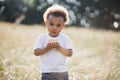 African american boy holding cupcake while posing on nature Royalty Free Stock Photo