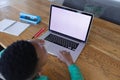 African american boy in online school class, using laptop, copy space on screen