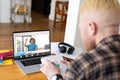 African american boy raising hand during online class with albino african american male teacher Royalty Free Stock Photo