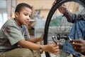 African American boy repairing bike Royalty Free Stock Photo