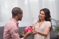 Boyfriend presenting gift to girlfriend on international womens day