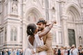 Multiracial wedding couple. Wedding in Florence, Italy. African-American bride and Caucasian groom cuddling in Piazza